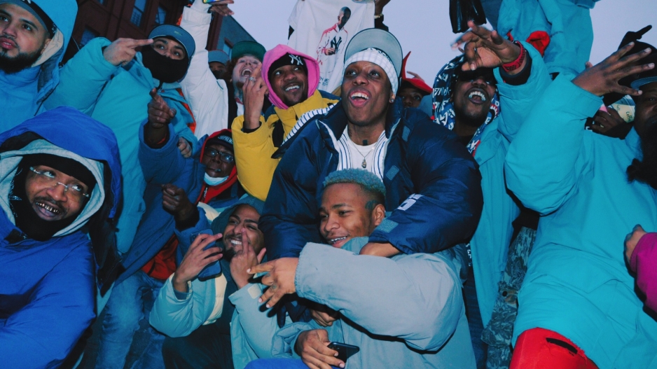 Group of Black men huddled in a circle