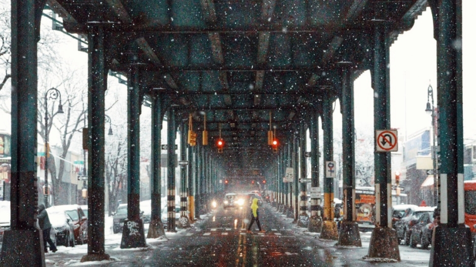 Street under elevated subway tracks.