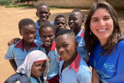 Javi smiling with school children from Senya Beraku, Ghana