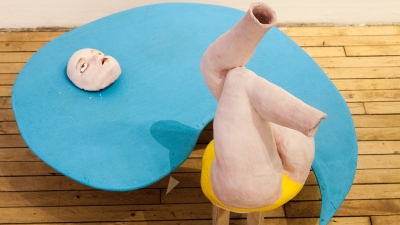 Sculpture of figure in blue form. 