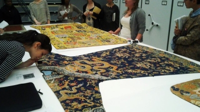 students examining fabric