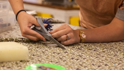 Student cutting fabric. 