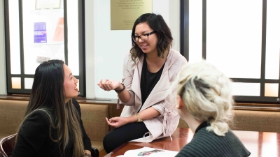 higher education students in an office talking to each other