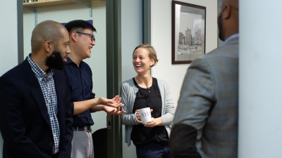 Faculty chatting outside an office