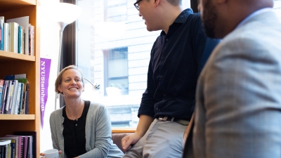 Professor Lisa Stulberg in her office talking with colleagues