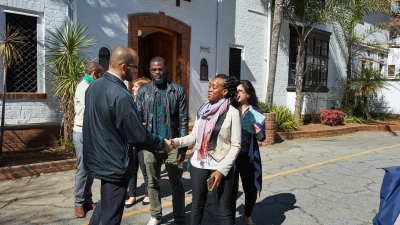 A young man and woman shaking hands.