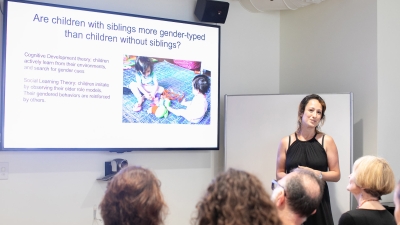 Woman presenting powerpoint in front of group