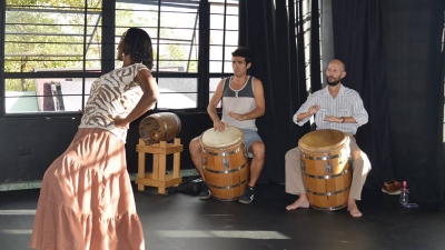 woman dancing and 2 drummers