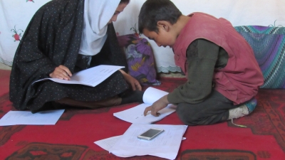 A teacher helping a child with schoolwork