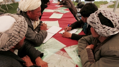 Group of men talking around a table