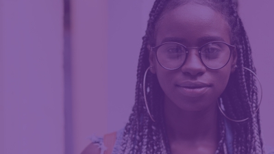 A young woman with braids and glasses with a purple filter over the image
