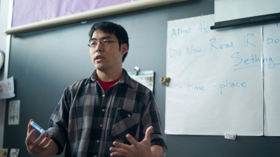 student teacher standing in front of a chalkboard