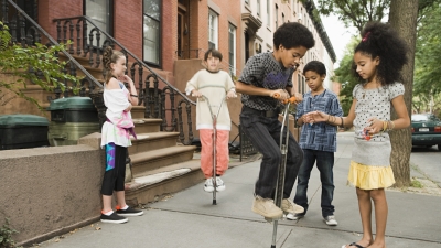 Children playing on the sidewalk