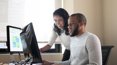 Two students looking at something on a computer