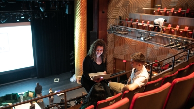 Students in the Skirball Theater with a laptop