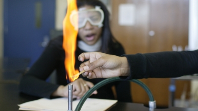 student doing an experiment with goggles