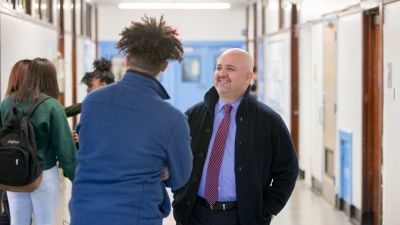 teacher talking to a student in the hallway
