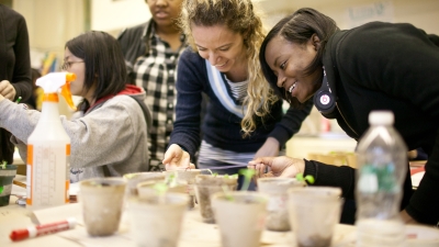 student laughing with teacher in a laboratory 