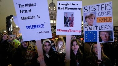 People holding banners in a protest march asking for tolerance