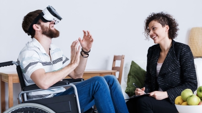 Man in wheelchair with virtual reality headset