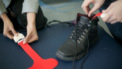 Physical therapist adding shoe inserts