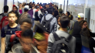 Inside the corridor of a high school packed with students