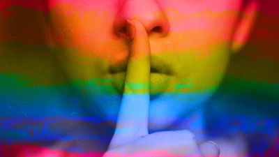a person holding a finger over their lips to indicate silence with rainbow colors on top of the image