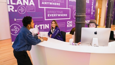 Students chatting at the front desk at the Welcome Center