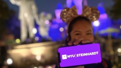 Admitted student celebrating by flashing NYU Steinhardt on her phone