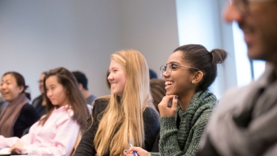 A diverse group of students enjoying a classroom lecture