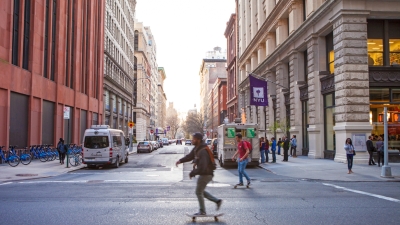 A skateboarder on Broadway racing past Washington Place 