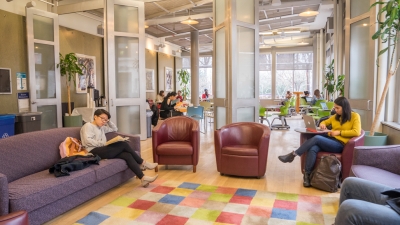 Students lounge and study in the first floor lounge at Pless Hall
