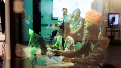 Students share their work via computer stations at a student expo