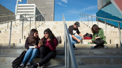 High school students gather on the stairs between classes. 