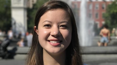 woman smiling on front of water fountain