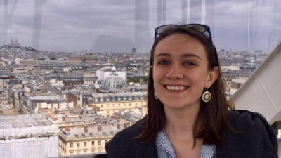 woman smiling with a city background