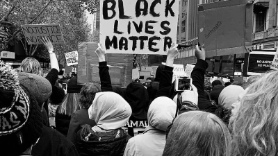 Protestors holding Black lives matter placard-street