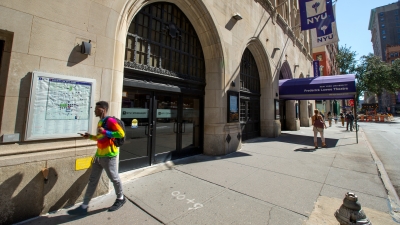 Students walking outside 35 West 4th Street on the NYU campus