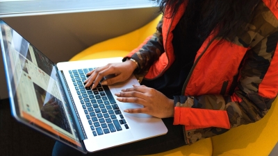 A woman doing school work on her laptop.