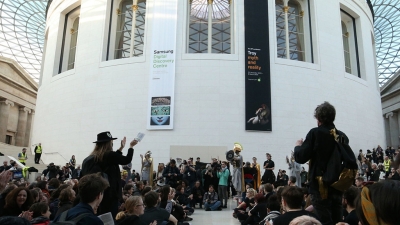 People in front of round building.