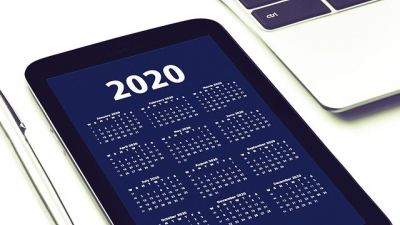 A tablet showing a screen with the header "2020" followed by a monthly calendar for the year. 