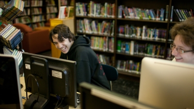 Students in Front of Bookshelves