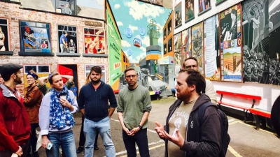 Students standing in front of art in Ireland. 