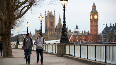 An image of NYU student walking down The Queen's Walk by River Thames with Big Ben in the background. 