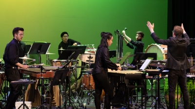 The NYU Percussion Ensemble performing on stage