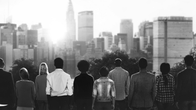Black and white photo of people looking at the skyline.