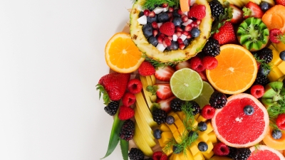 A photo of a variety of citrus fruits cut up and arranged on a white tabletop