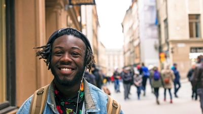 Smiling student walking on campus