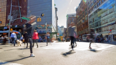 Busy NYC street scene of people crossing the street at Union Square