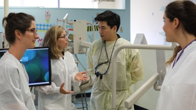 NYU students talk amongst themselves during their experiential learning program in a dentist's office